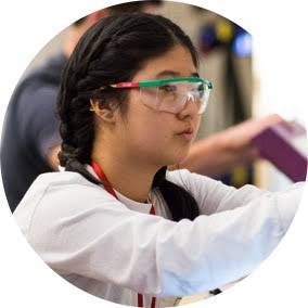 Female student with glasses researching in a lab.