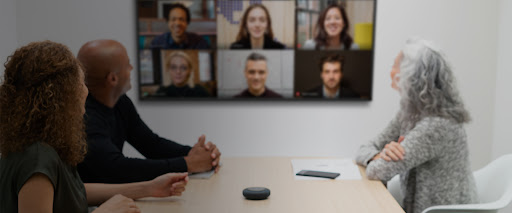 Office workers starting Google Meet from touch controller